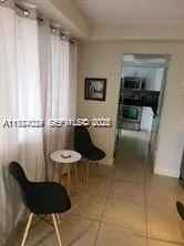 a living room with furniture and a air conditioner vent