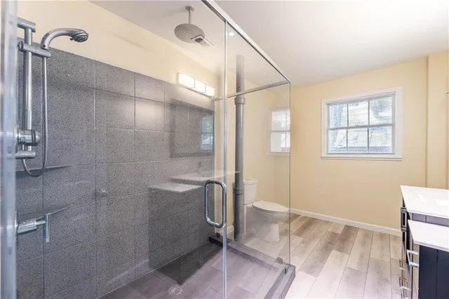 a bathroom with a shower and a sink