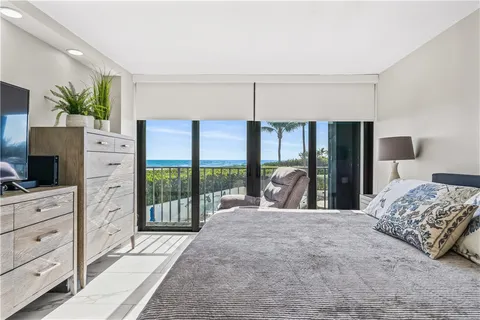 a large bedroom with a large bed and a flat tv screen