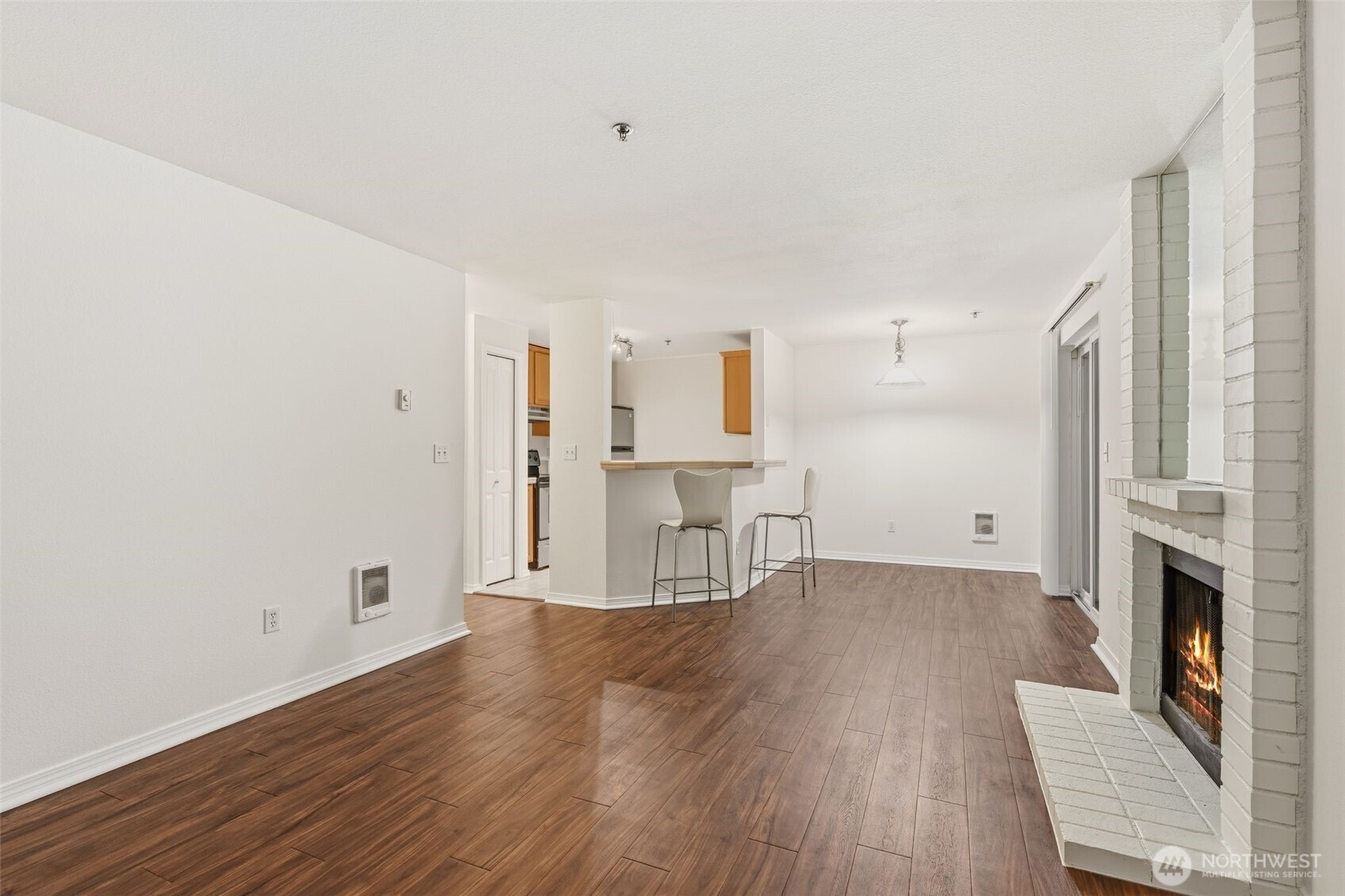 11527 Highway 99, Unit C106 Everett, WA 98204 - Photo 13 of 21 a view of empty room with wooden floor and fireplace