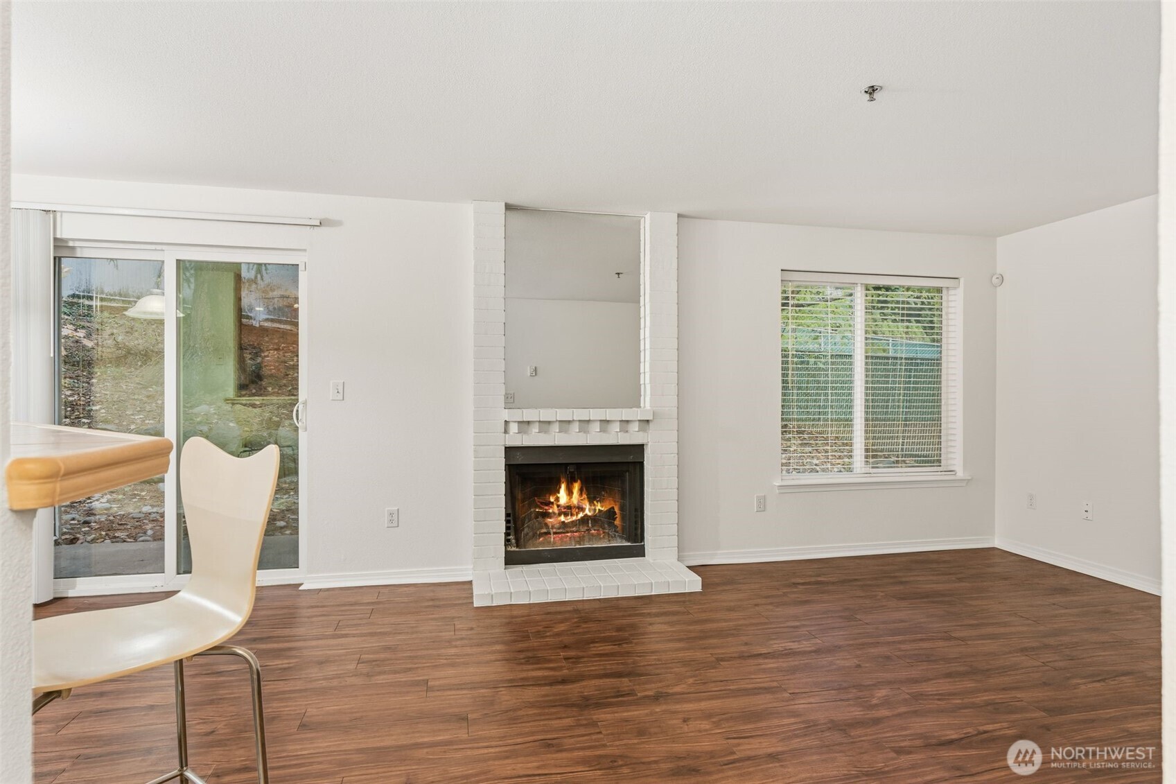 11527 Highway 99, Unit C106 Everett, WA 98204 - Photo 2 of 21 a view of wooden floor fire place and windows in a room