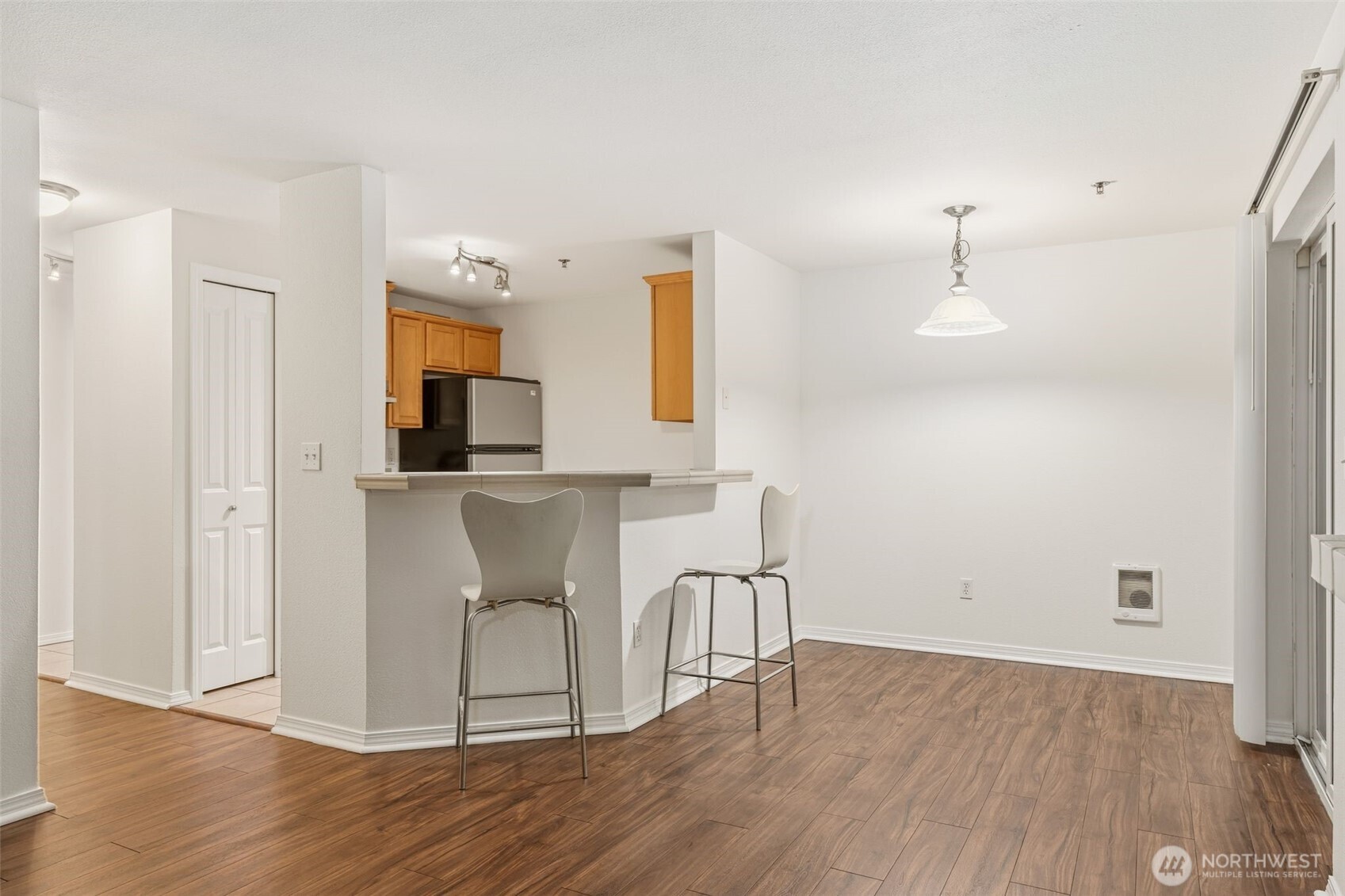 11527 Highway 99, Unit C106 Everett, WA 98204 - Photo 3 of 21 a view of a kitchen with wooden floor and electronic appliances