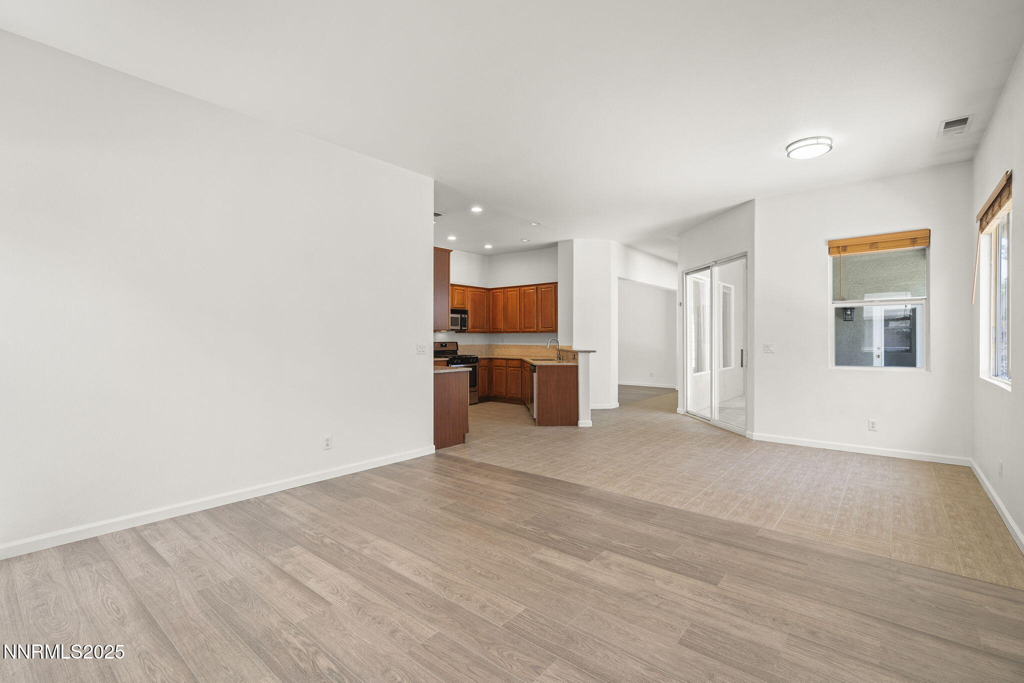 10452 Copper Wood Court Reno, NV 89521 - Photo 15 of 30 a view of a livingroom with wooden floor and a kitchen