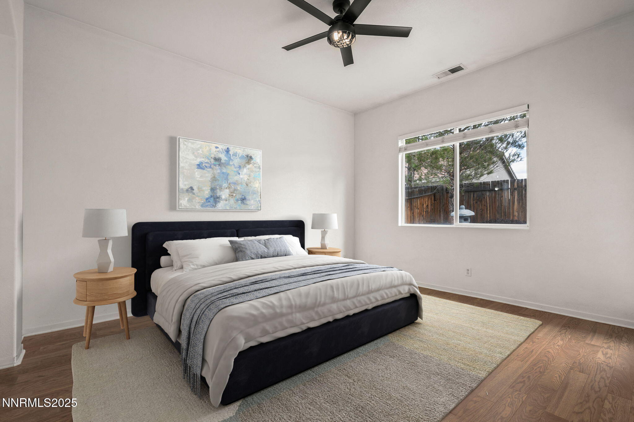 10452 Copper Wood Court Reno, NV 89521 - Photo 20 of 30 a bedroom with a bed lamp and a window