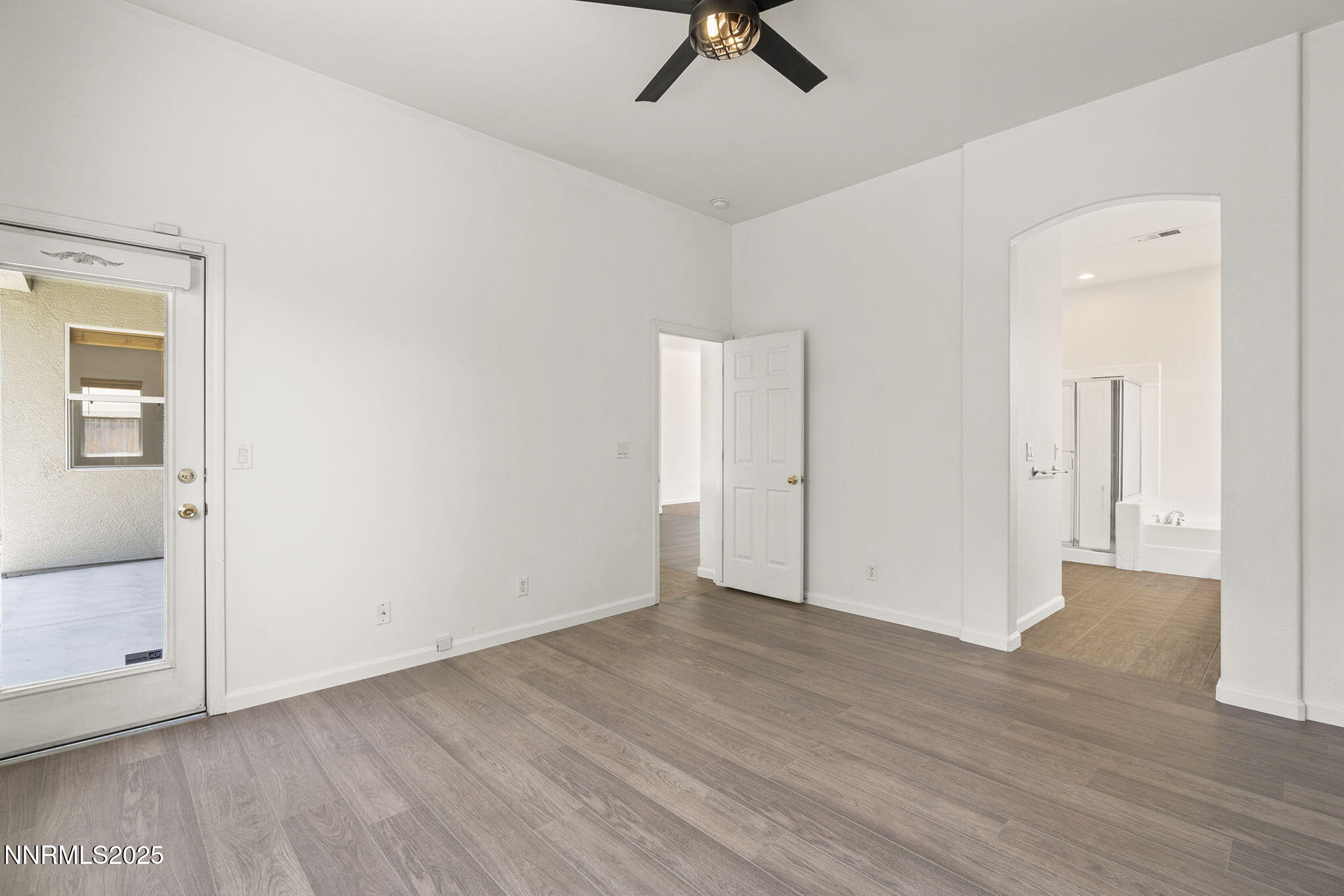 10452 Copper Wood Court Reno, NV 89521 - Photo 21 of 30 an empty room with wooden floor and windows