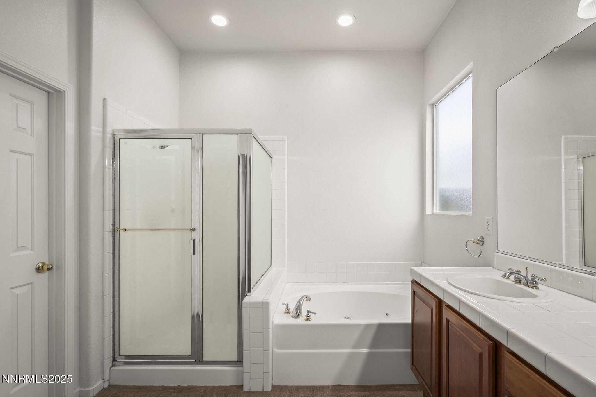 10452 Copper Wood Court Reno, NV 89521 - Photo 23 of 30 a bathroom with a tub sink and mirror