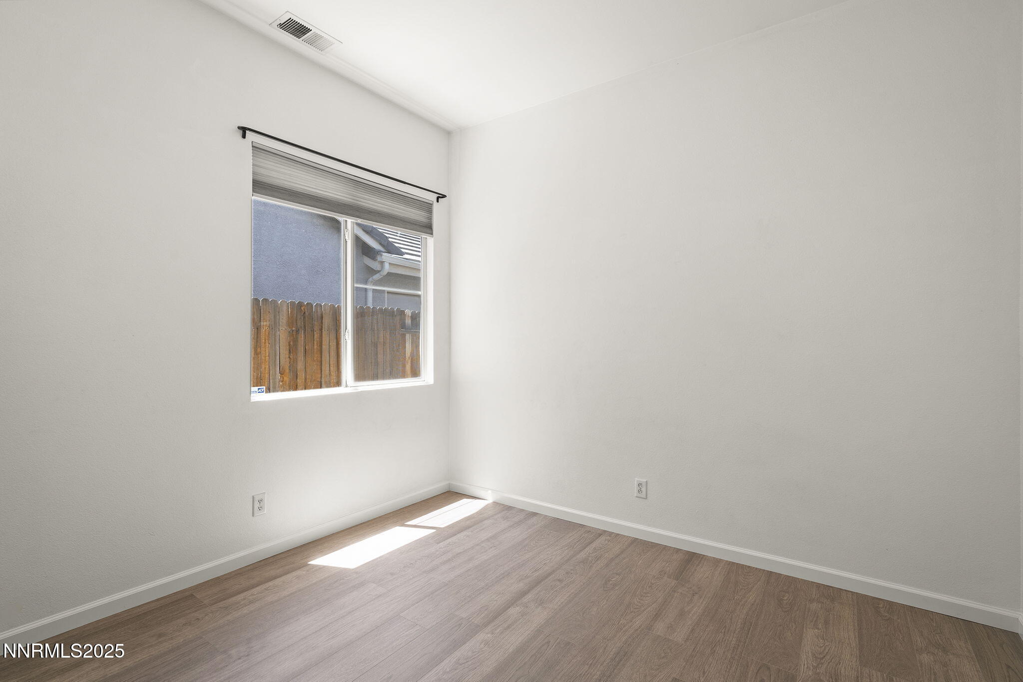 10452 Copper Wood Court Reno, NV 89521 - Photo 25 of 30 a view of an empty room with wooden floor and a window