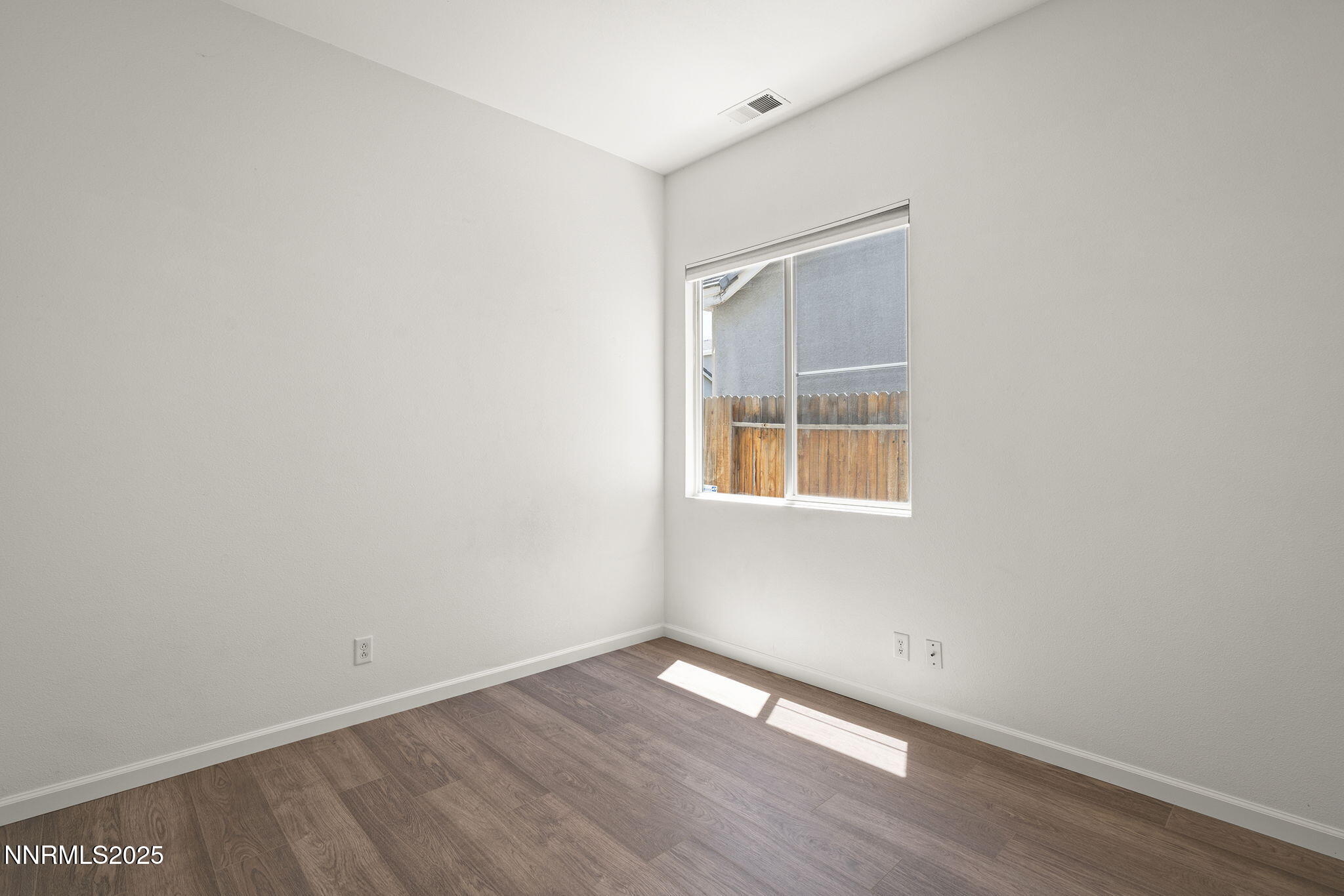 10452 Copper Wood Court Reno, NV 89521 - Photo 26 of 30 a view of an empty room with wooden floor and a window
