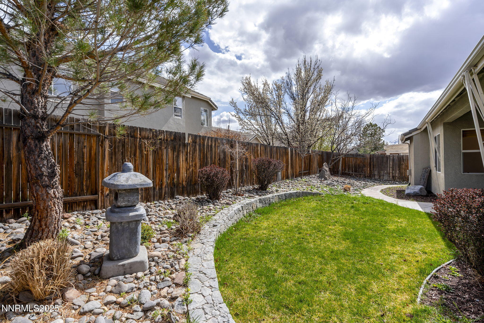 10452 Copper Wood Court Reno, NV 89521 - Photo 28 of 30 a view of a backyard with table and chairs potted plants and wooden fence