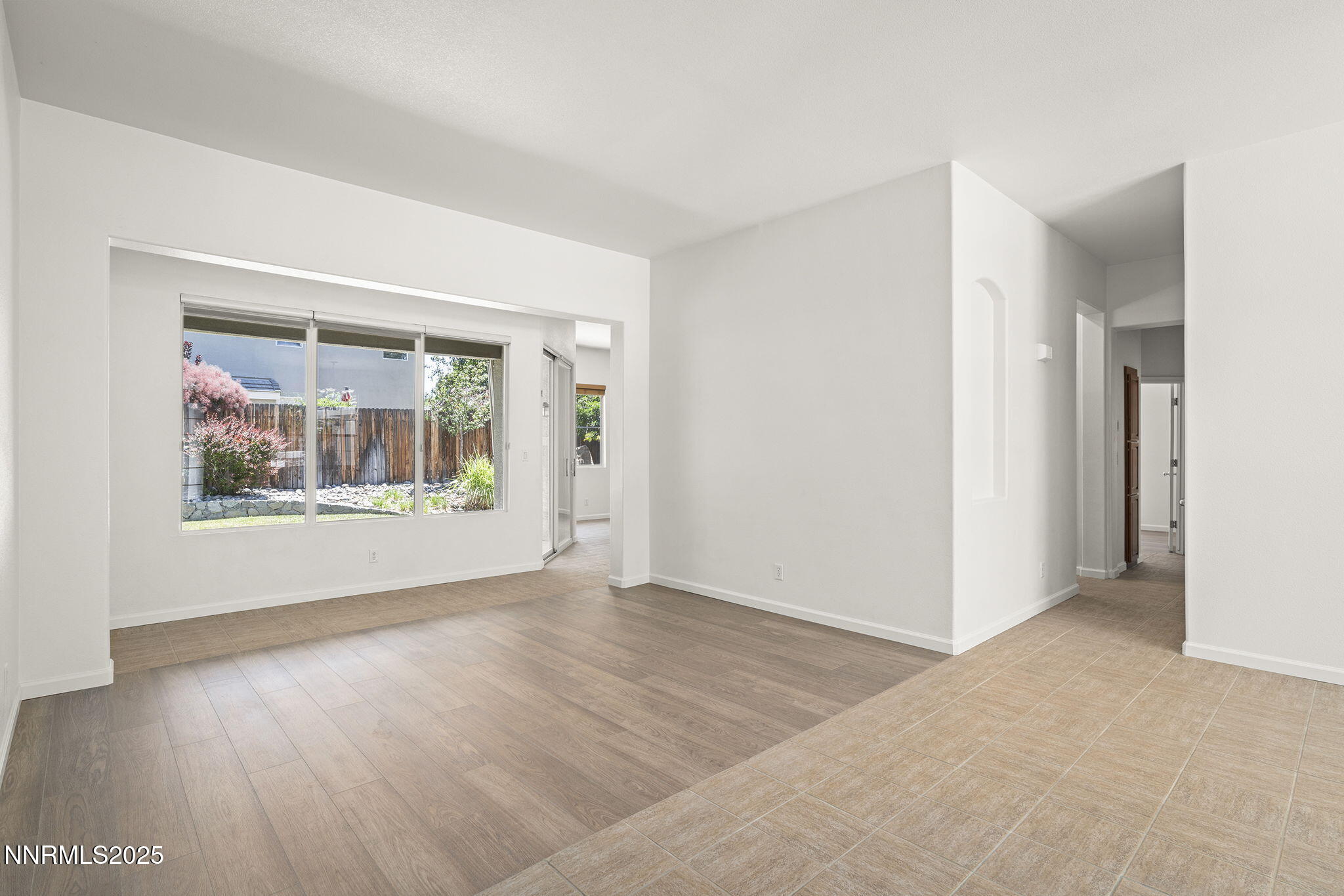 10452 Copper Wood Court Reno, NV 89521 - Photo 4 of 30 an empty room with wooden floor and windows