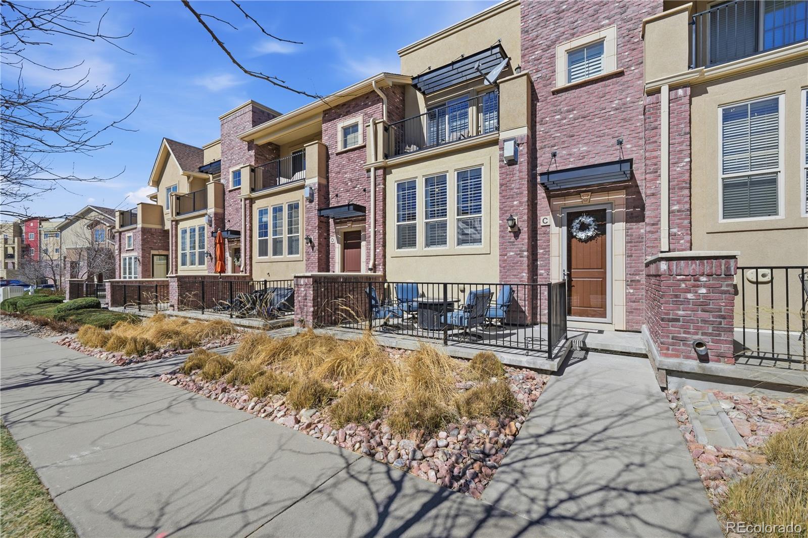 950 Elmhurst Drive, Unit C Highlands Ranch, CO 80129 - Photo 2 of 31 a view of a building with a yard