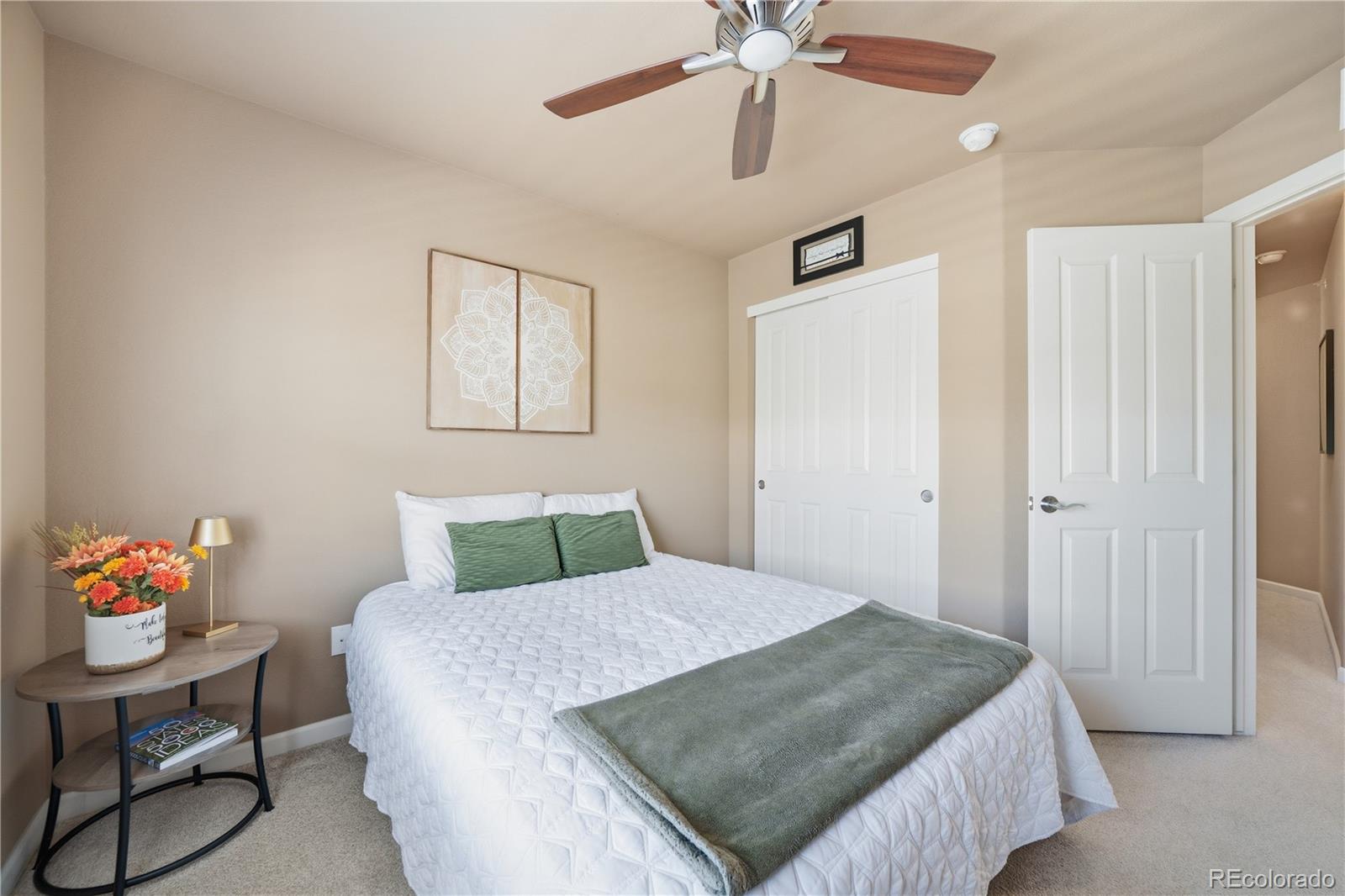 950 Elmhurst Drive, Unit C Highlands Ranch, CO 80129 - Photo 22 of 31 a bedroom with a bed and a chandelier