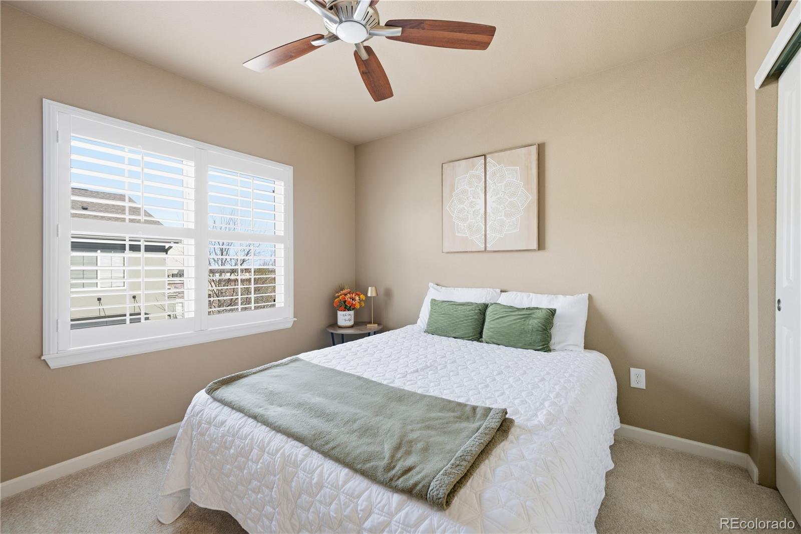 950 Elmhurst Drive, Unit C Highlands Ranch, CO 80129 - Photo 23 of 31 a bedroom with a bed and window