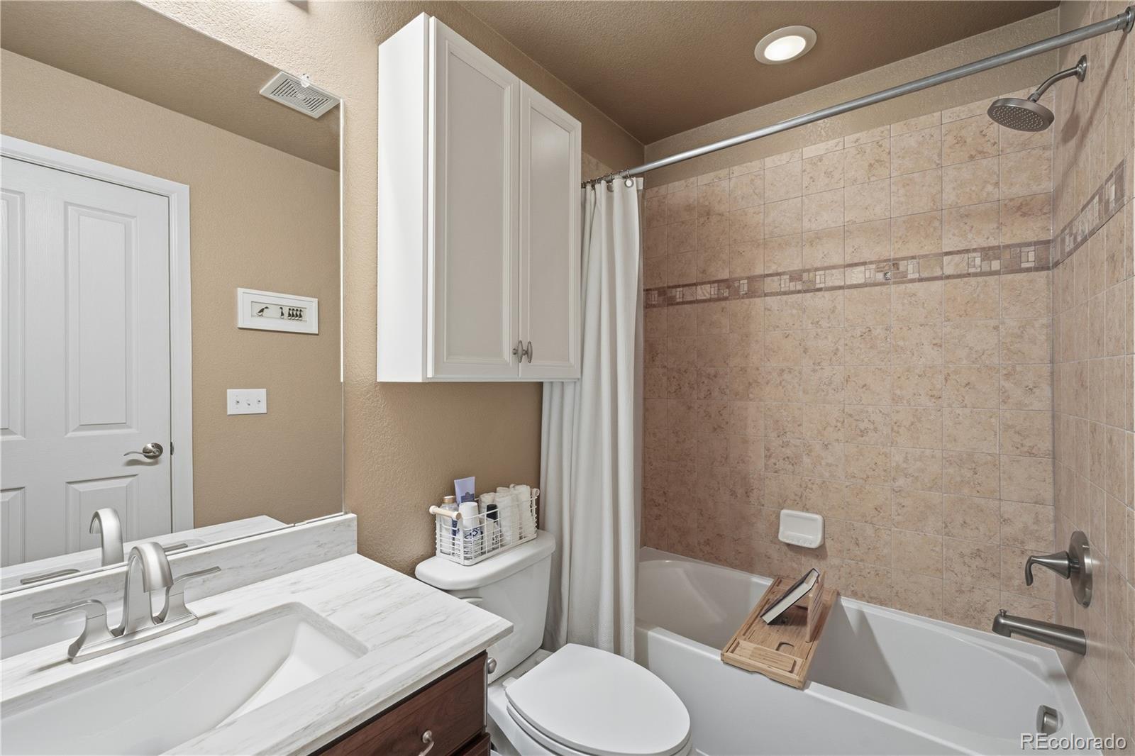 950 Elmhurst Drive, Unit C Highlands Ranch, CO 80129 - Photo 24 of 31 a bathroom with a sink toilet and shower