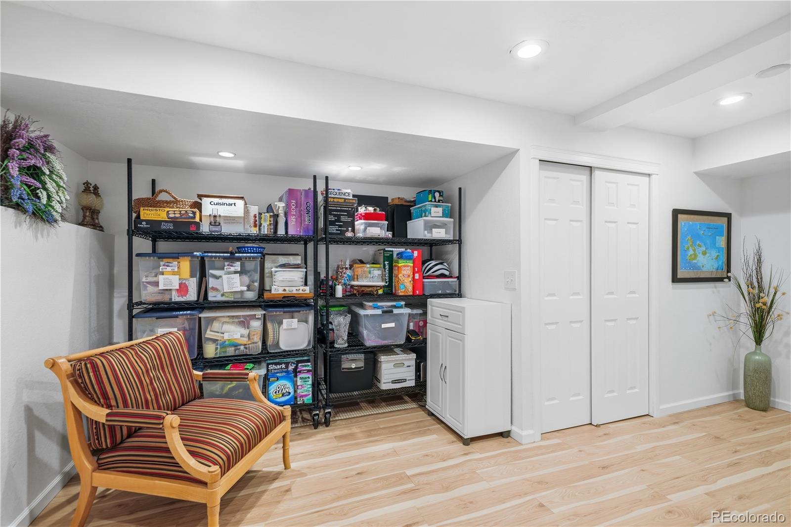950 Elmhurst Drive, Unit C Highlands Ranch, CO 80129 - Photo 26 of 31 a living room with furniture a bookshelf and a book shelf