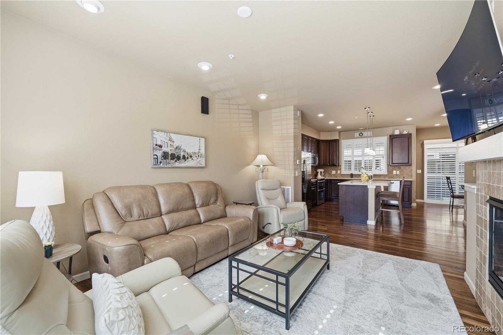 950 Elmhurst Drive, Unit C Highlands Ranch, CO 80129 - Photo 6 of 31 a living room with furniture kitchen view and a table