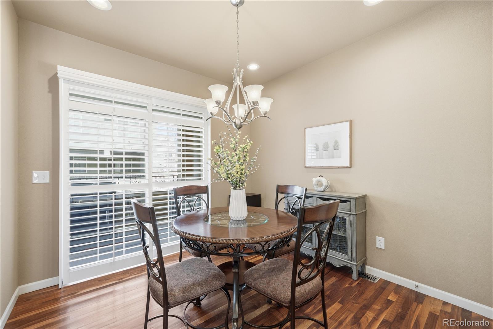 950 Elmhurst Drive, Unit C Highlands Ranch, CO 80129 - Photo 10 of 31 a view of a dining room with furniture wooden floor and a chandelier