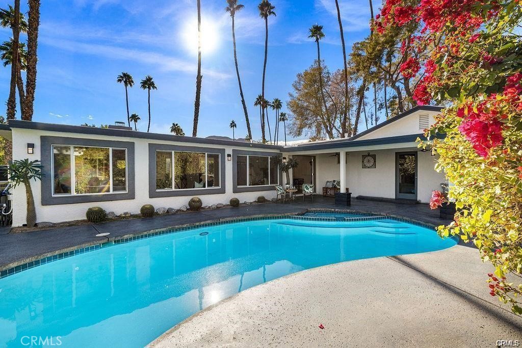 a view of an house with swimming pool and porch