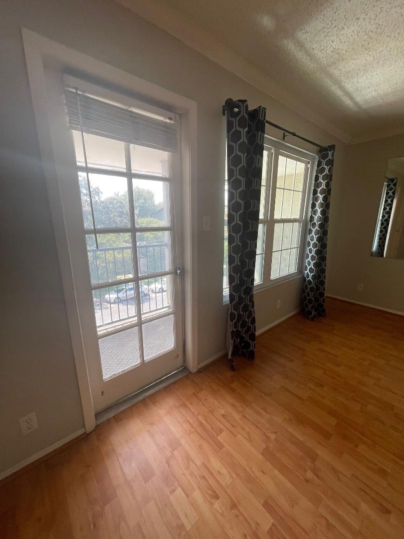 910 Duncan Lane, Unit 44 Austin, TX 78705 - Photo 8 of 15 Sun-filled room boasts light wood flooring and generous windows.