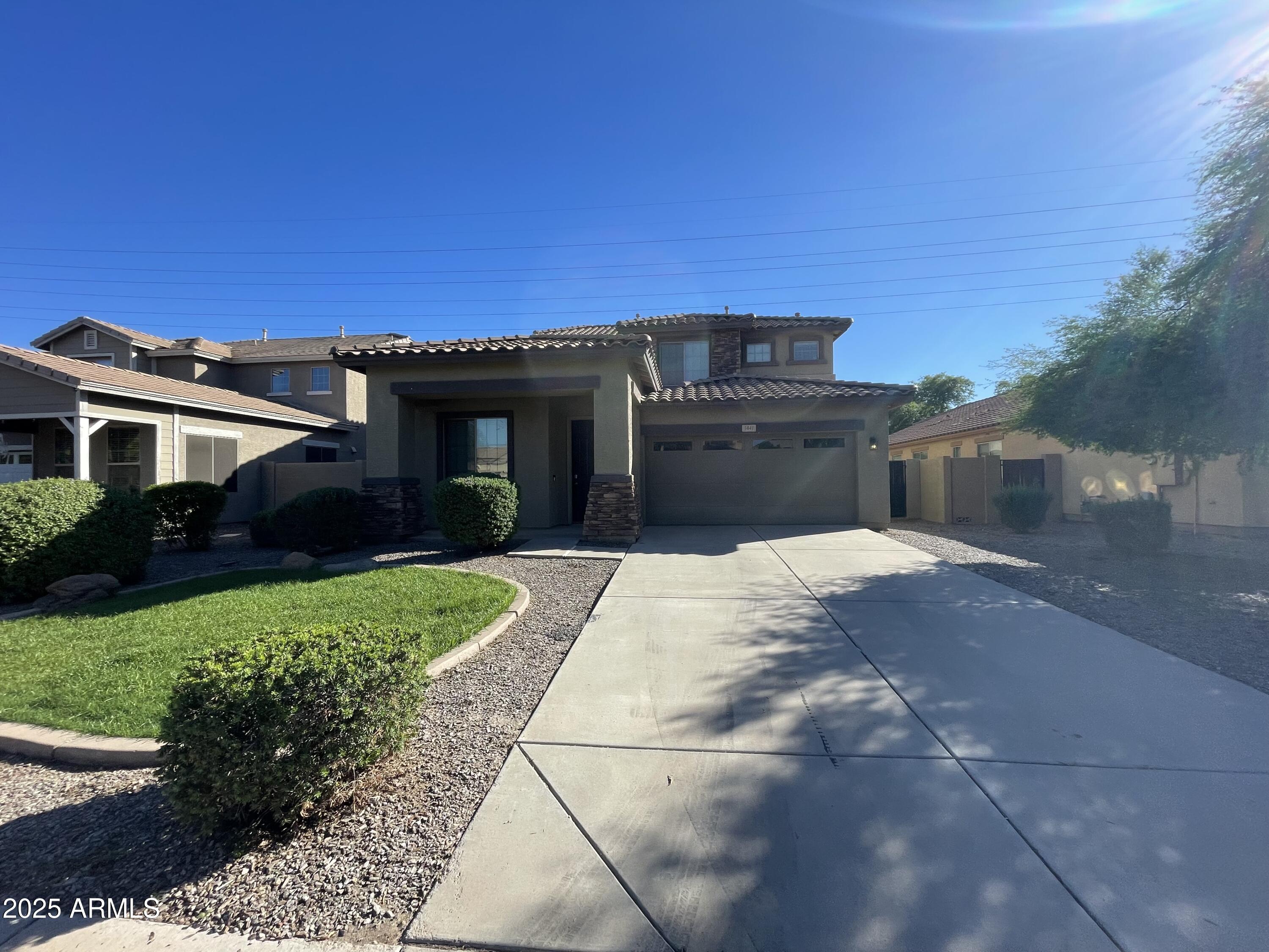 1441 East Thornton Avenue Gilbert, AZ 85297 - Photo 1 of 13 a front view of a house with a yard