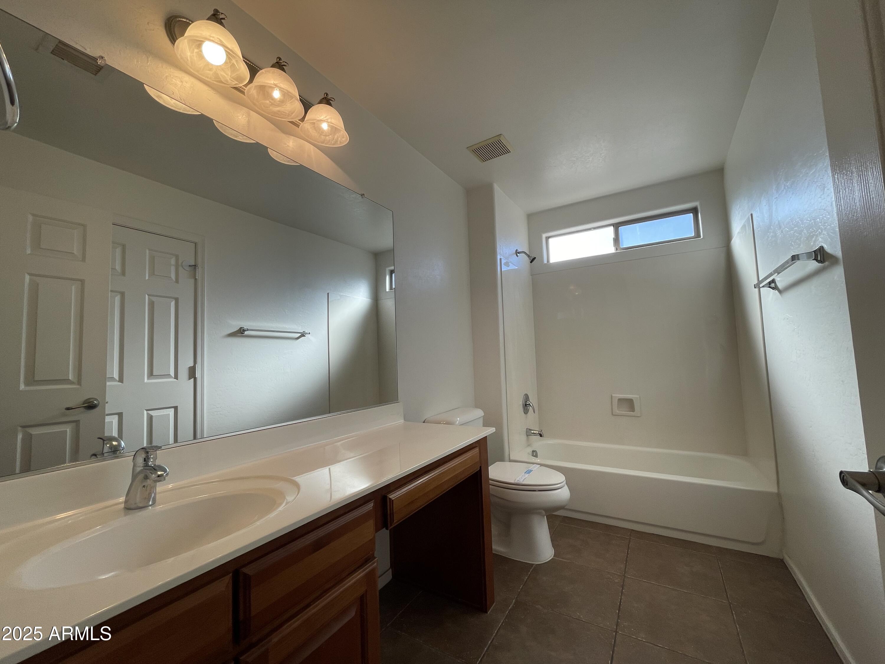 1441 East Thornton Avenue Gilbert, AZ 85297 - Photo 11 of 13 a bathroom with a double vanity sink toilet and shower