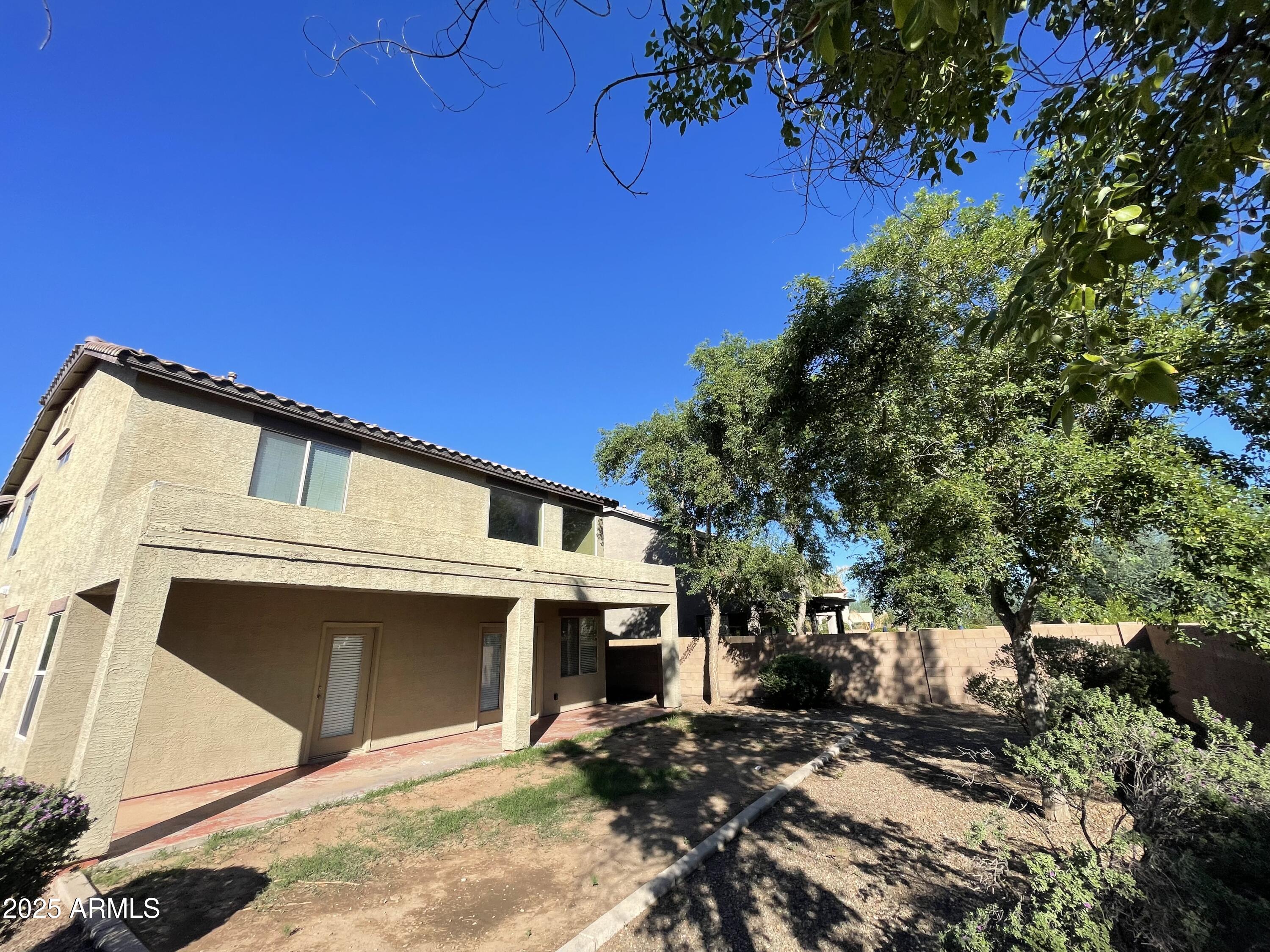 1441 East Thornton Avenue Gilbert, AZ 85297 - Photo 3 of 13 a front view of a house with a yard