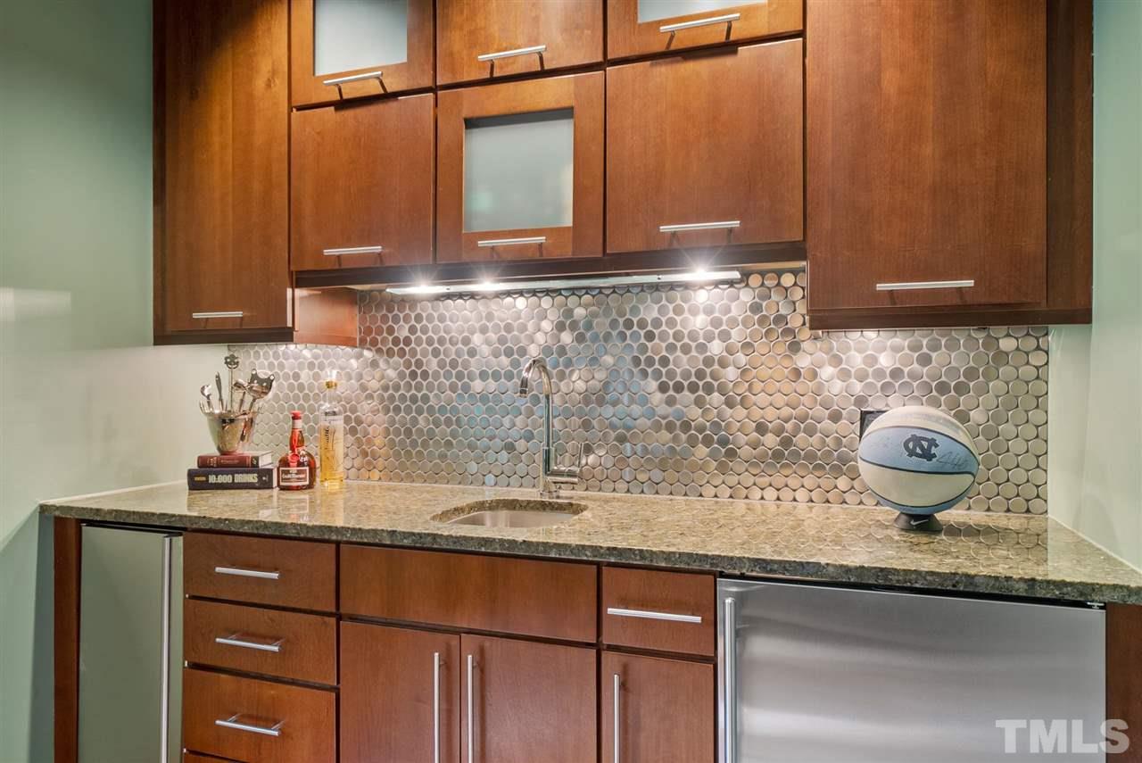 4028 John S Raboteau Wynd Raleigh, NC 27612 - Photo 13 of 30 a kitchen with a sink and cabinets