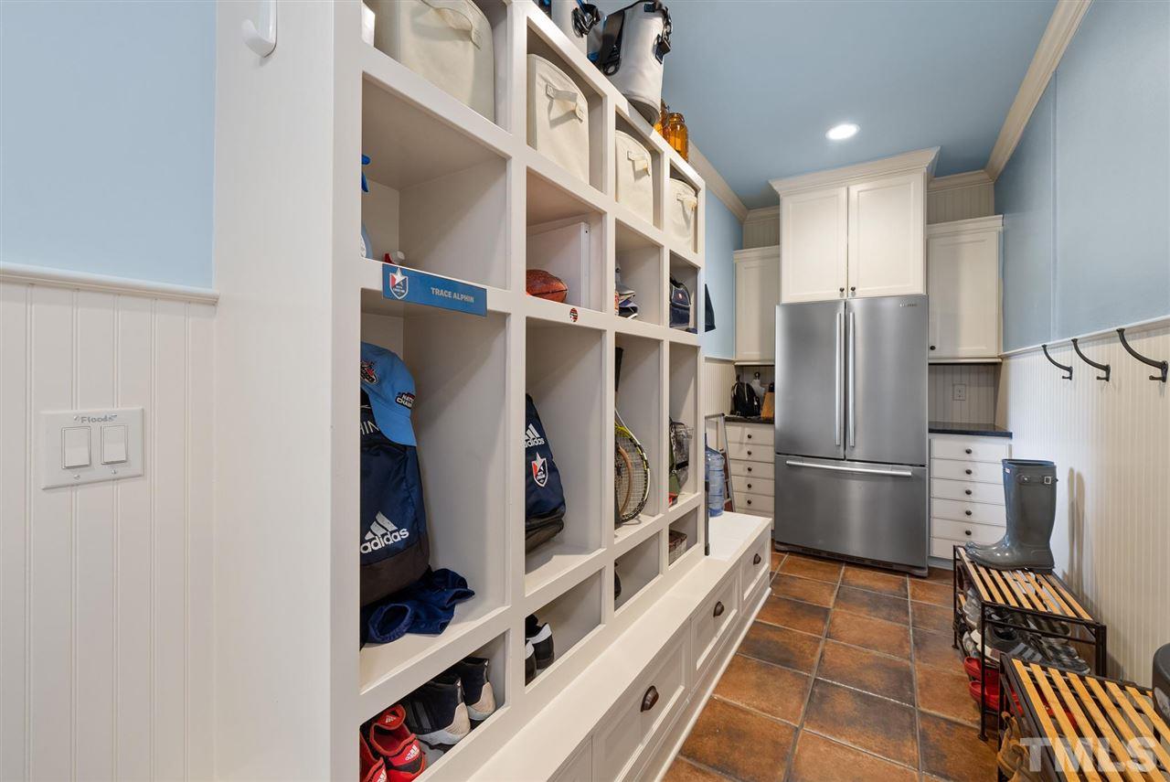 4028 John S Raboteau Wynd Raleigh, NC 27612 - Photo 16 of 30 a kitchen with refrigerator and cabinets