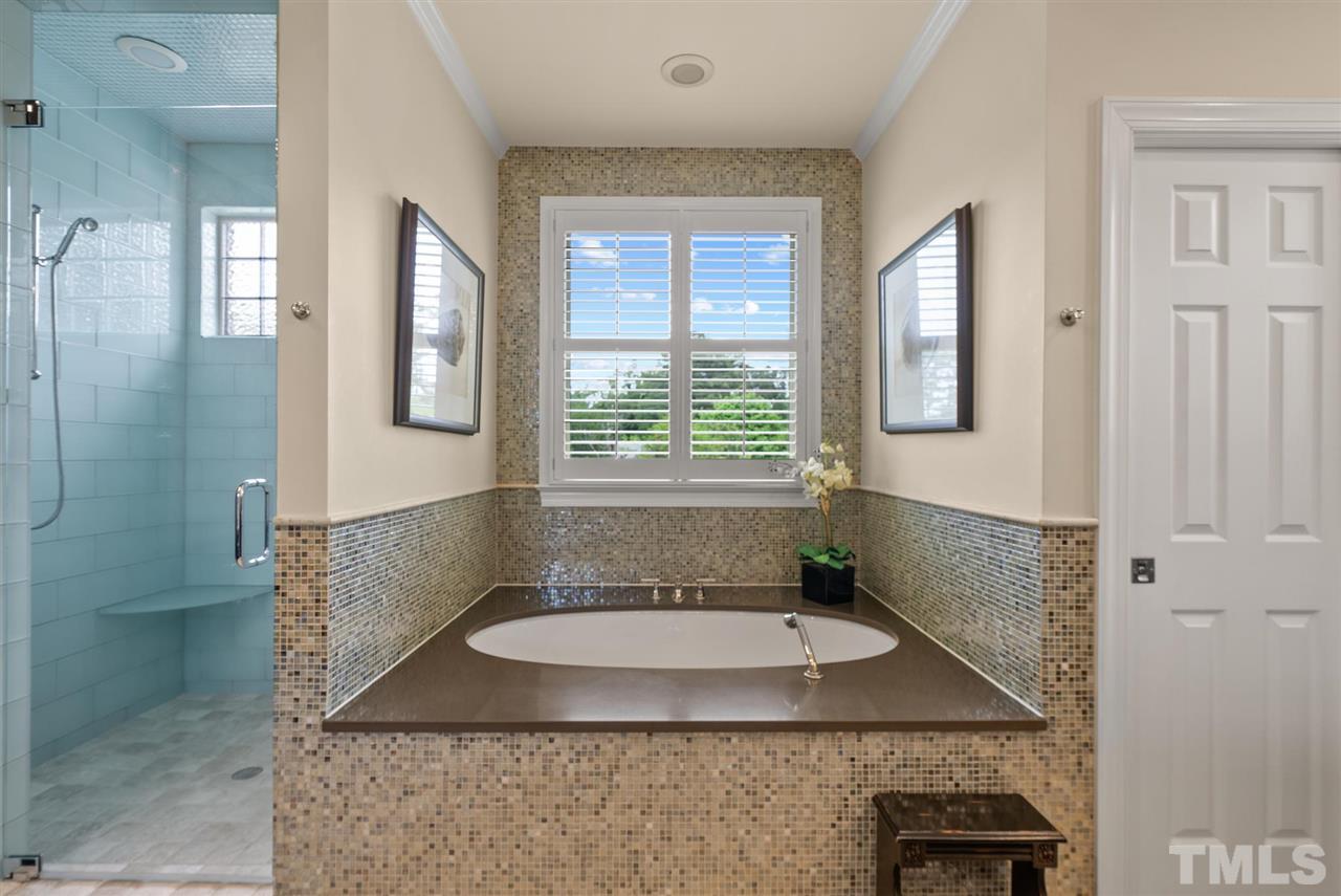 4028 John S Raboteau Wynd Raleigh, NC 27612 - Photo 18 of 30 a bathroom with a granite countertop sink a toilet and shower
