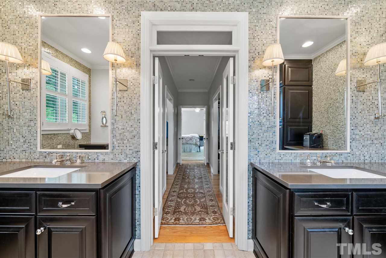 4028 John S Raboteau Wynd Raleigh, NC 27612 - Photo 19 of 30 a bathroom with a sink and a mirror