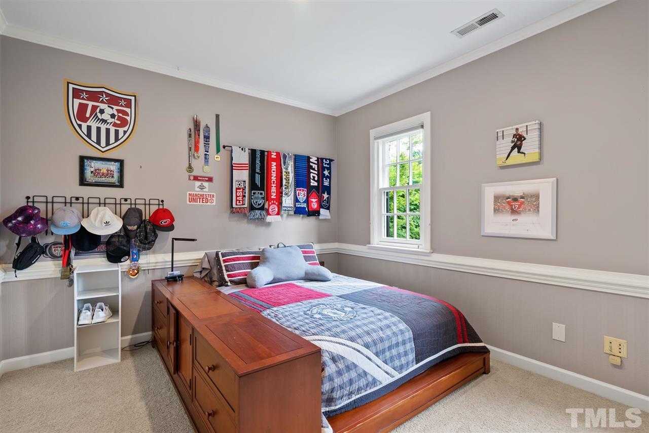 4028 John S Raboteau Wynd Raleigh, NC 27612 - Photo 21 of 30 a bedroom with a bed and a window