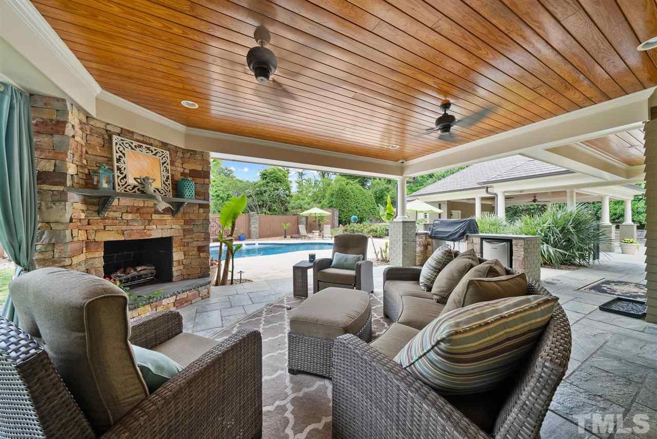 4028 John S Raboteau Wynd Raleigh, NC 27612 - Photo 24 of 30 a living room with furniture a fireplace and a large window