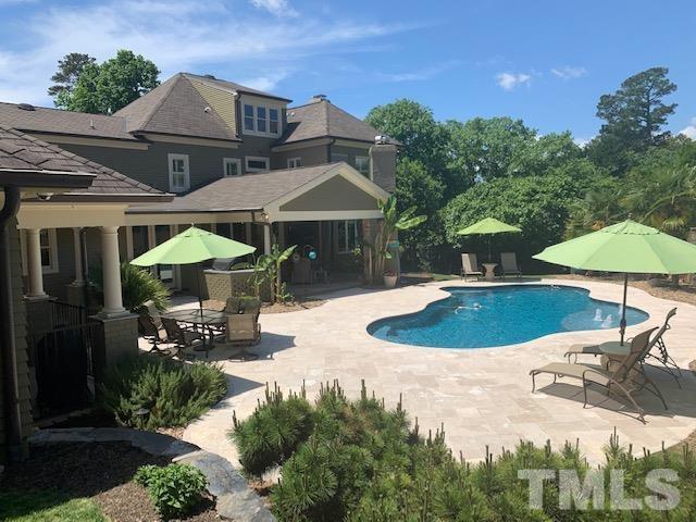 4028 John S Raboteau Wynd Raleigh, NC 27612 - Photo 27 of 30 an outdoor space with pool and furniture