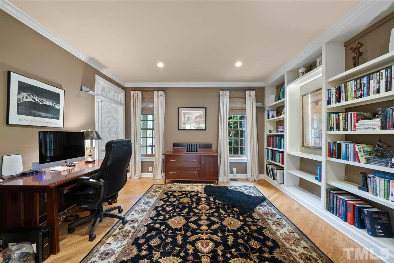 4028 John S Raboteau Wynd Raleigh, NC 27612 - Photo 5 of 30 a bedroom with a workspace and a bookshelf