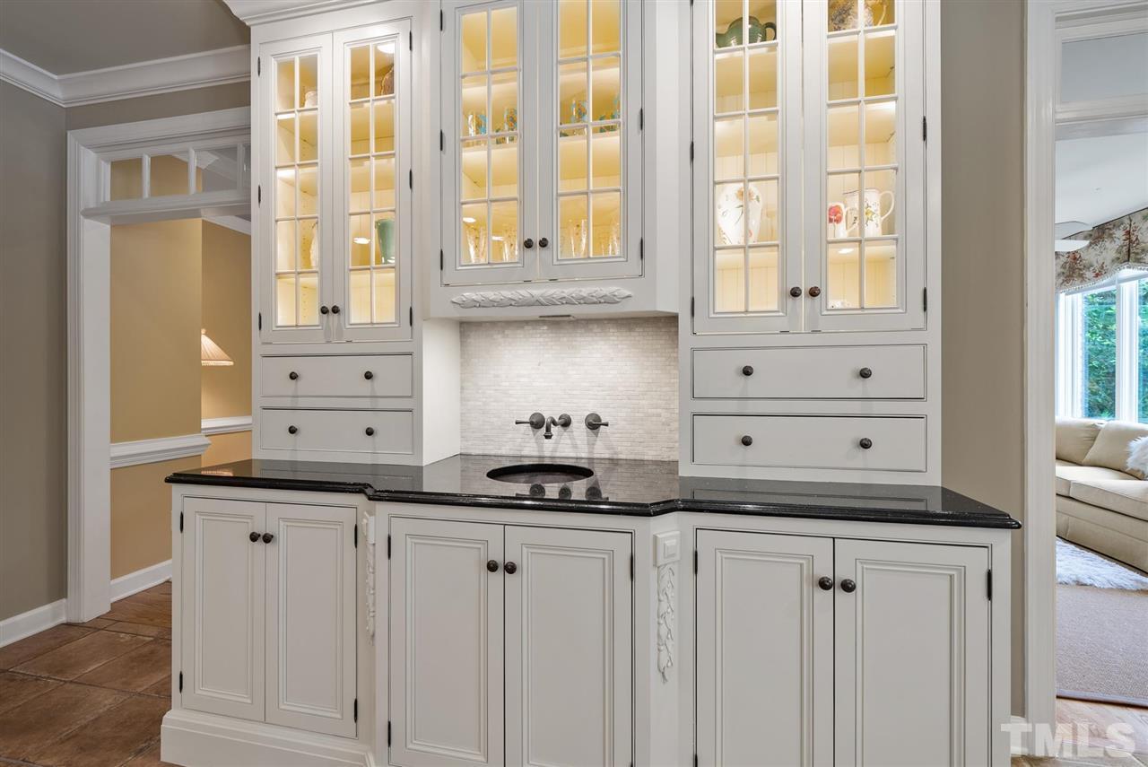 4028 John S Raboteau Wynd Raleigh, NC 27612 - Photo 10 of 30 a kitchen with granite countertop a sink and a white cabinets