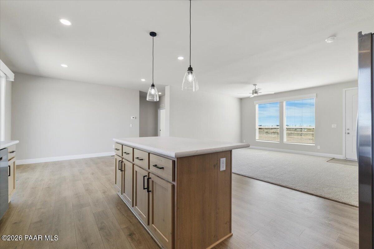 7366 East Bunkhouse Road Prescott Valley, AZ 86315 - Photo 11 of 25 a kitchen with stainless steel appliances granite countertop a stove and a wooden floor