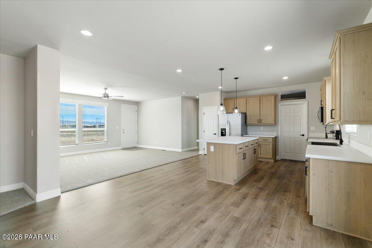 7366 East Bunkhouse Road Prescott Valley, AZ 86315 - Photo 13 of 25 a large kitchen with a lot of counter space and a wooden floor