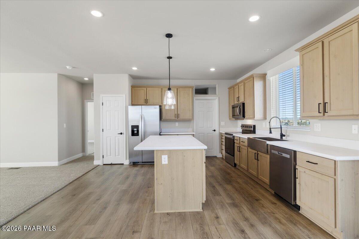 7366 East Bunkhouse Road Prescott Valley, AZ 86315 - Photo 14 of 25 a large kitchen with stainless steel appliances a large counter top a sink a refrigerator and a window