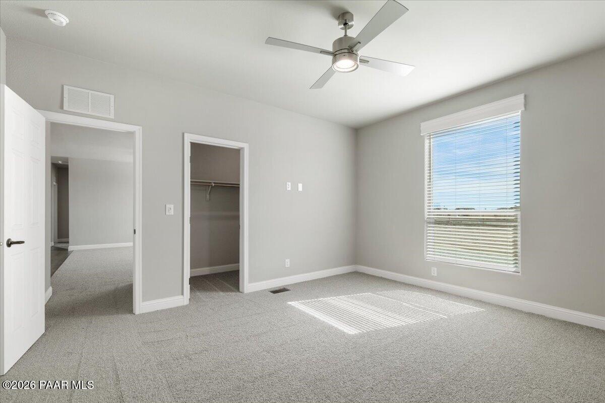 7366 East Bunkhouse Road Prescott Valley, AZ 86315 - Photo 19 of 25 an empty room with windows and fan