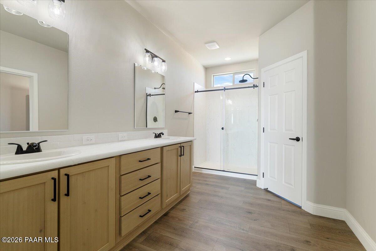 7366 East Bunkhouse Road Prescott Valley, AZ 86315 - Photo 21 of 25 a bathroom with a double vanity sink mirror and shower
