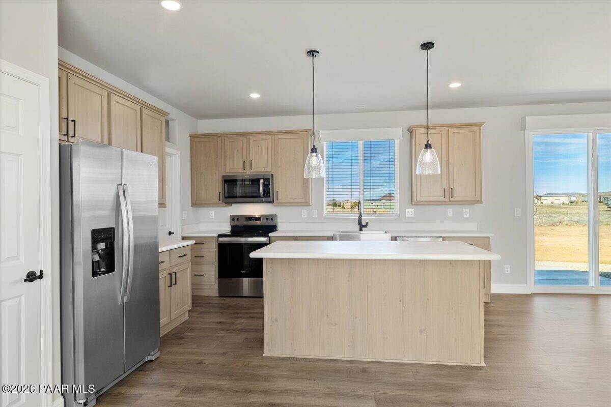7366 East Bunkhouse Road Prescott Valley, AZ 86315 - Photo 9 of 25 a kitchen with kitchen island a sink stainless steel appliances and refrigerator