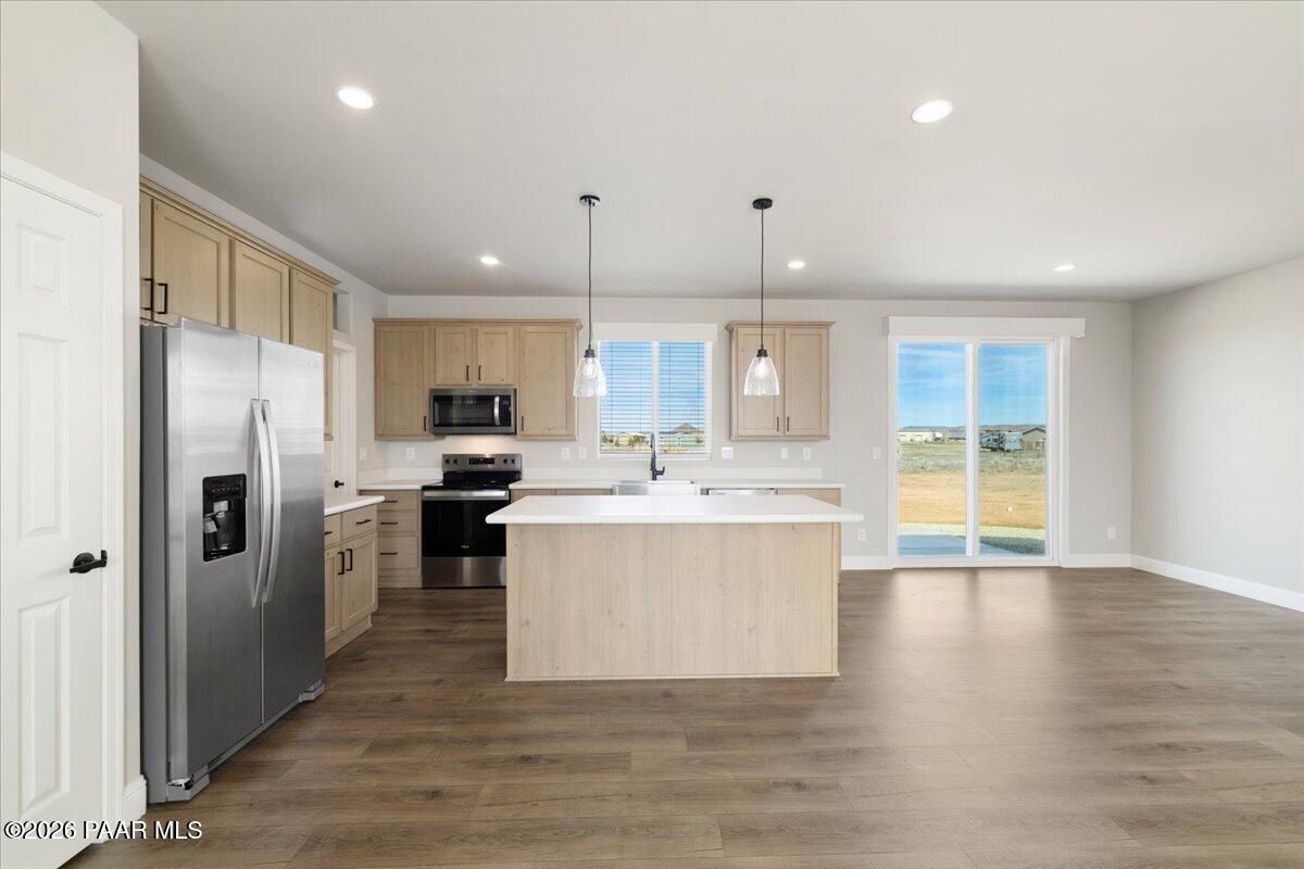 7366 East Bunkhouse Road Prescott Valley, AZ 86315 - Photo 10 of 25 a large kitchen with stainless steel appliances a large counter top a sink and a refrigerator
