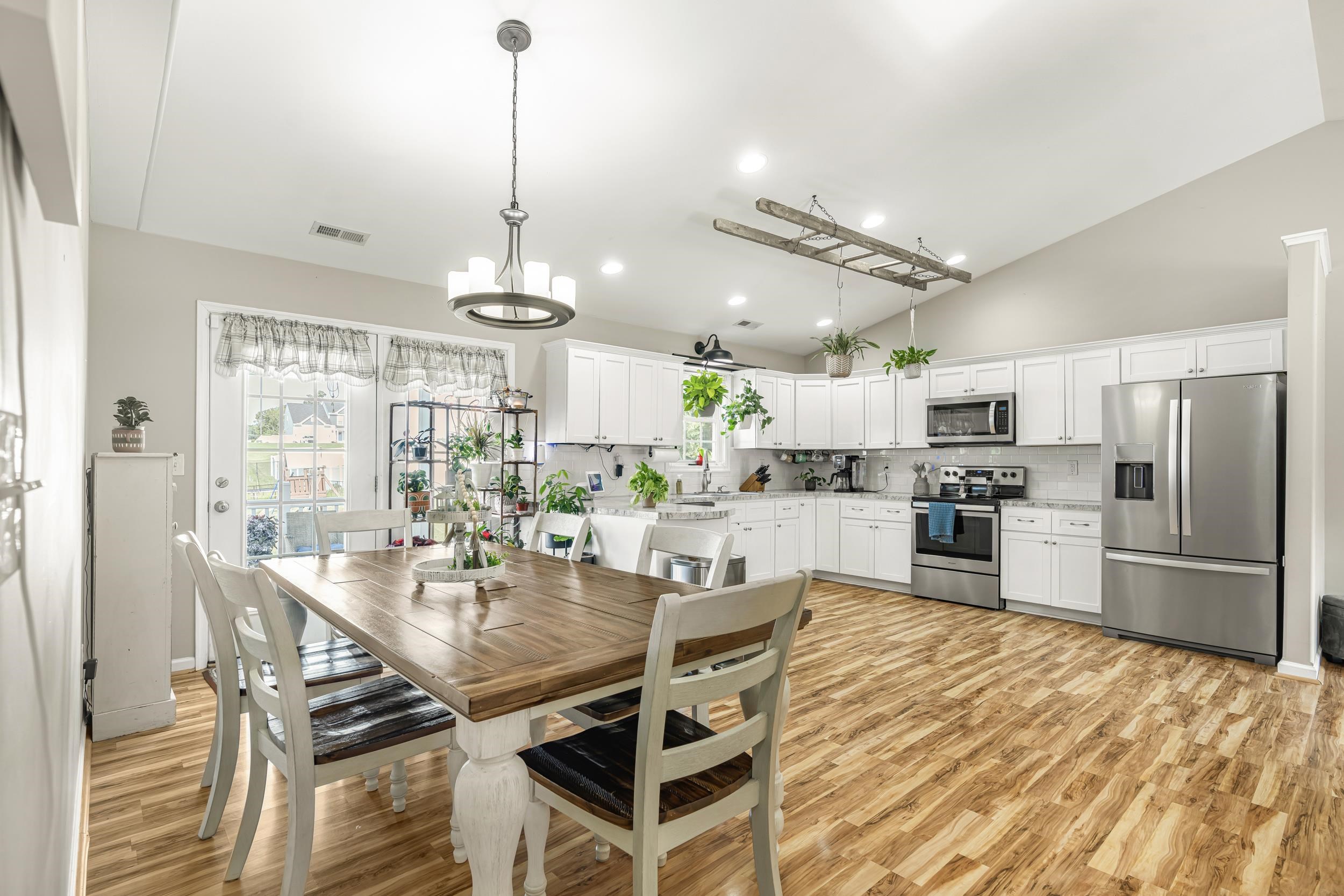 96 Lofty Circle Stuarts Draft, VA 24477 - Photo 13 of 69 a view of a dining room and livingroom with furniture wooden floor a chandelier