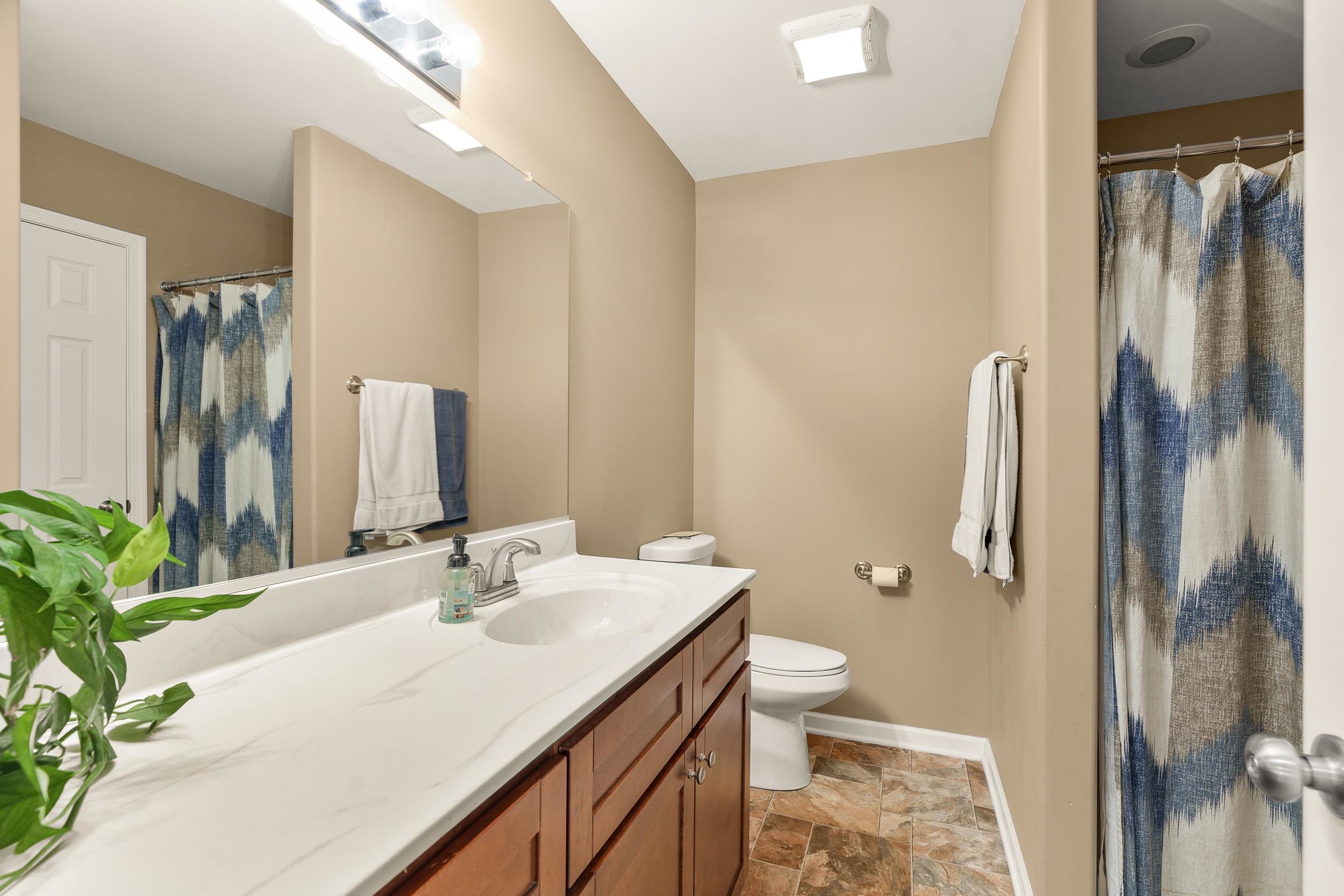 96 Lofty Circle Stuarts Draft, VA 24477 - Photo 37 of 69 a bathroom with a granite countertop sink toilet and shower