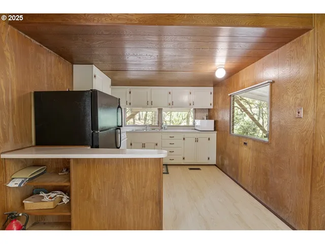 a kitchen with stainless steel appliances granite countertop a refrigerator a sink and a stove