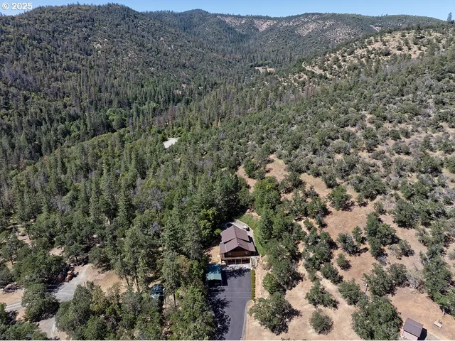 an aerial view of a house with a yard