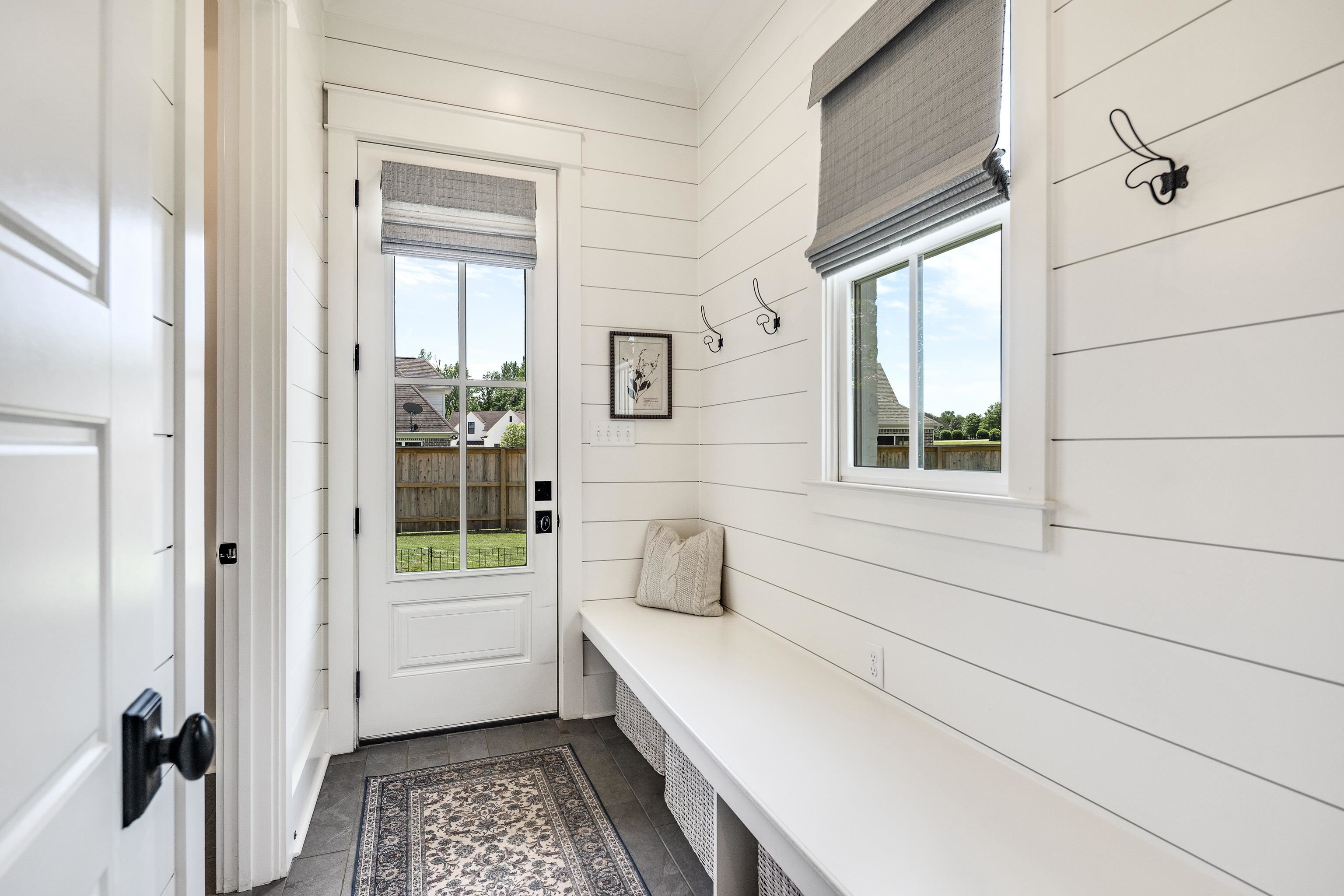 100 Sunflower View Road Piperton, TN 38017 - Photo 14 of 29 Entryway featuring shiplap walls, built-in bench with storage cubbies, and a glass-paneled door