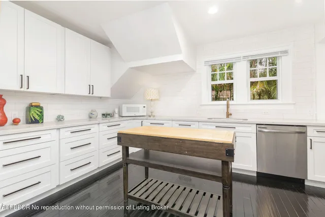 a kitchen with a stove a sink and cabinets