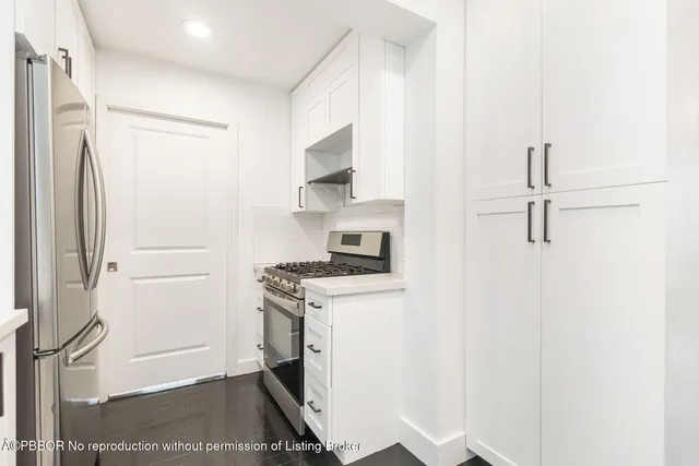a kitchen with a stove and a refrigerator