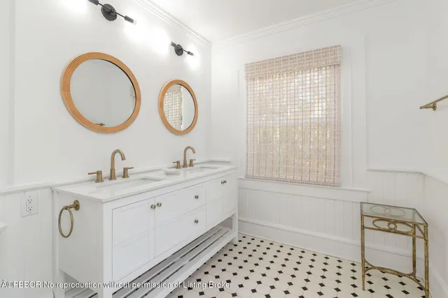 a bathroom with a double vanity sink mirror and bathtub